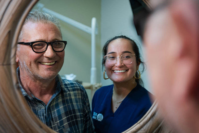 male patient looking into new smile