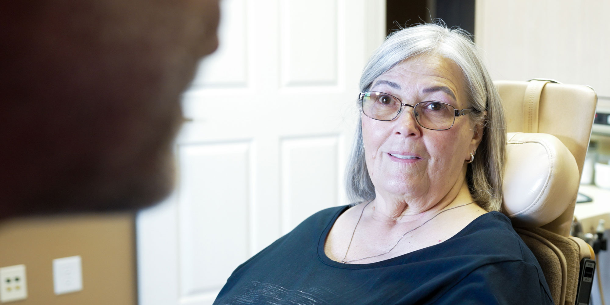 sharon listening to the dr on her full arch dental implants