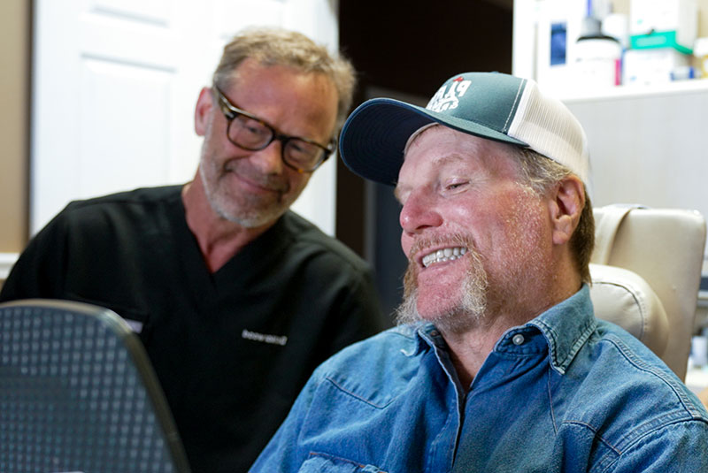 man with jean jacket looking at mirror amazed full arch