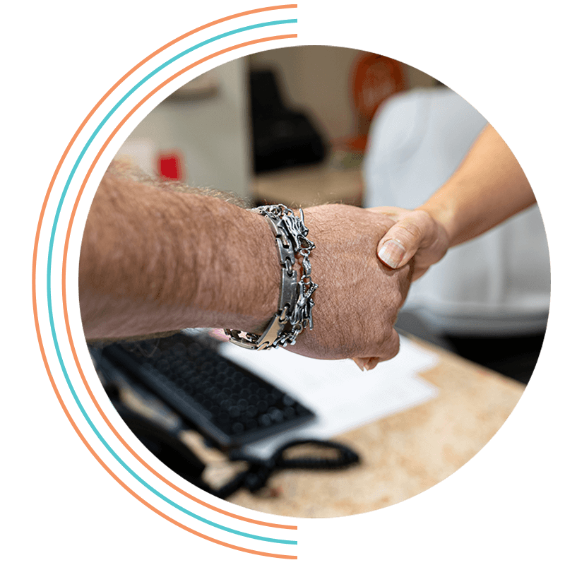 man with nice braclet shaking hands with coordinator for dental implants