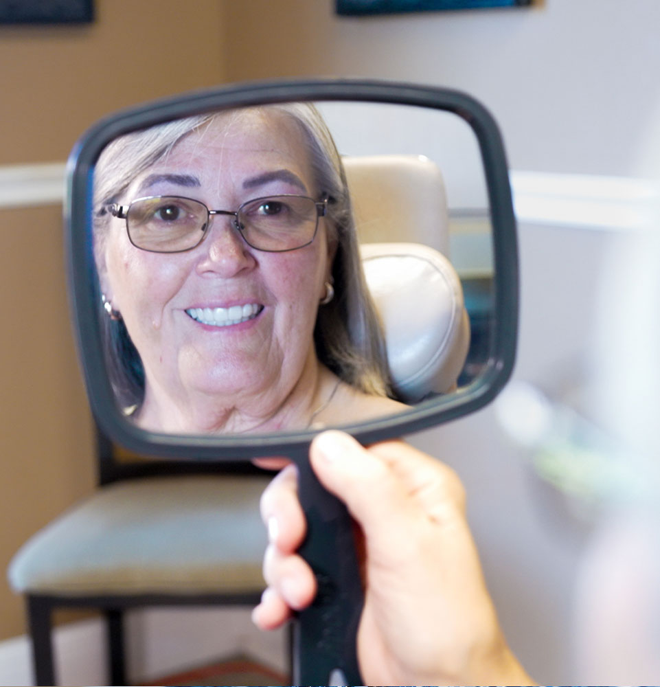 sharon looking at her new dental implants