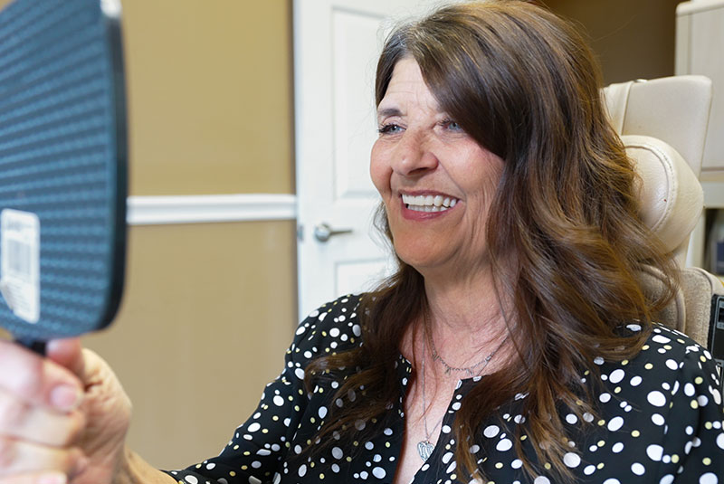 dental implant patient with mirror female