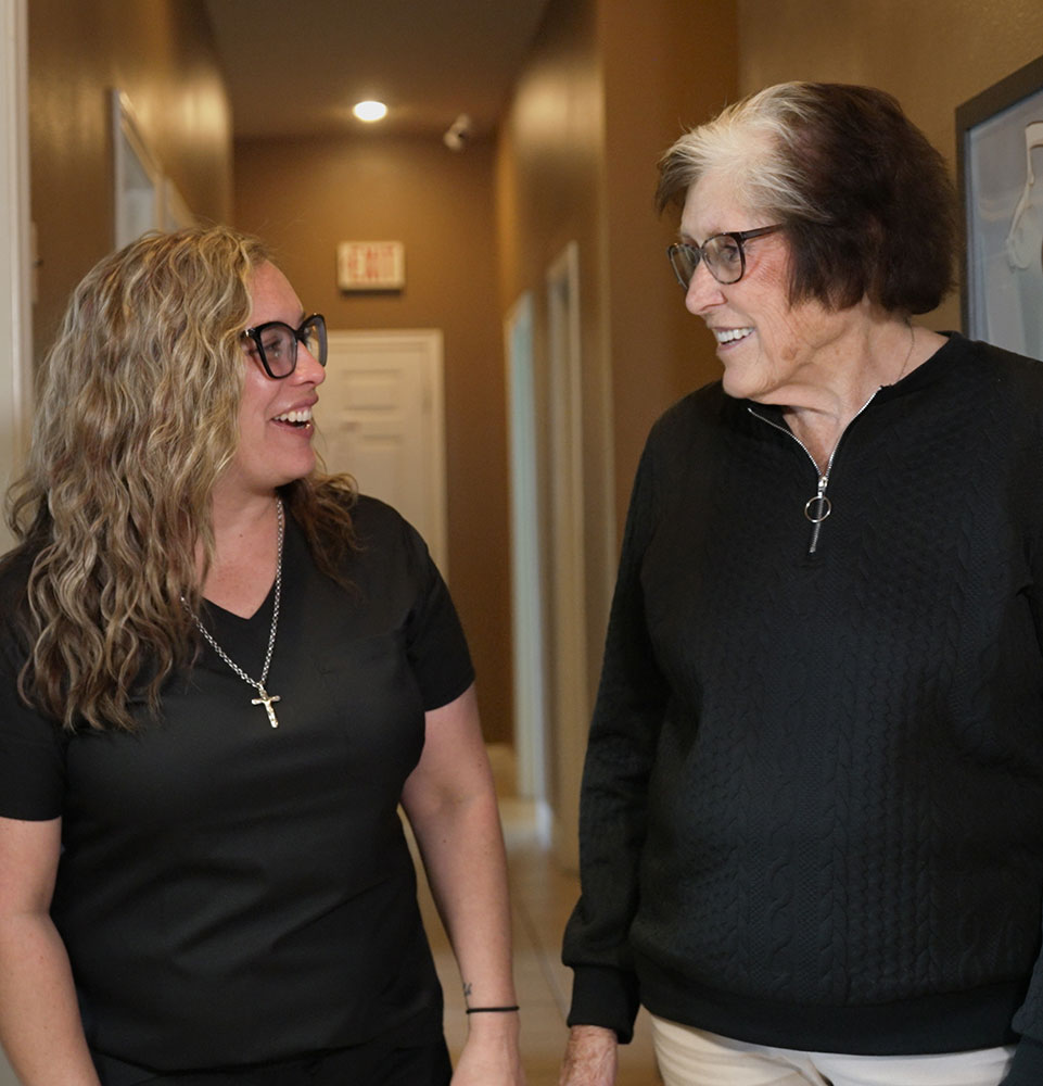 susan with jacket walking down hall