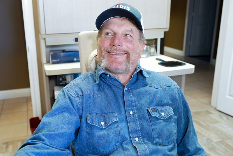 man with hat during consult for full arch