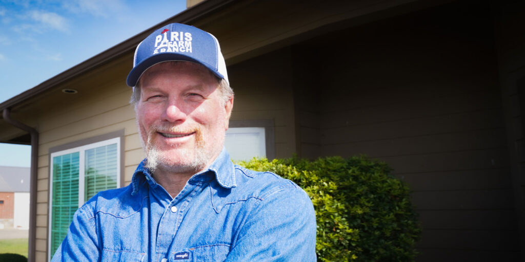 brain wearing paris hat and with new full arch dental implants